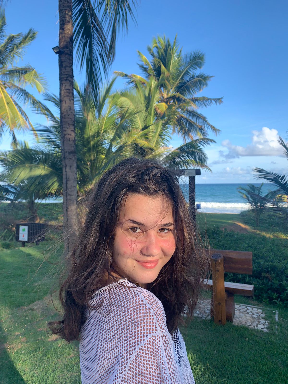 Ester na praia entre coqueiros